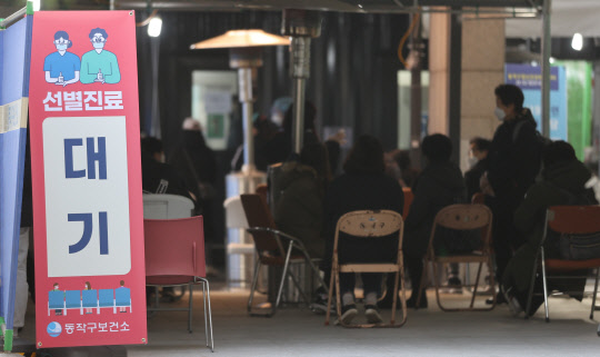 코로나19 신규 확진자가 이틀째 600명대를 기록한 7일 오전 서울 동작구 보건소에 마련된 선별진료소에서 시민들이 검사를 받기위해 대기하고 있다.  연합뉴스